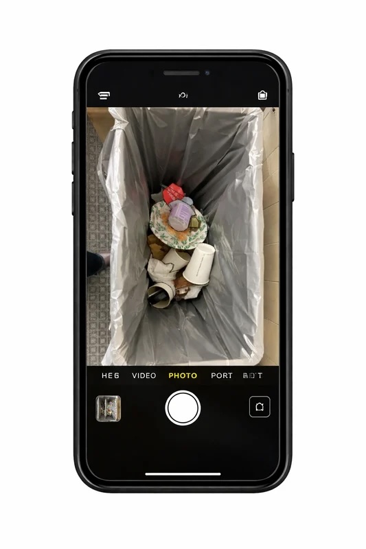 Phone capturing a waste bin photo for Rego AI analysis